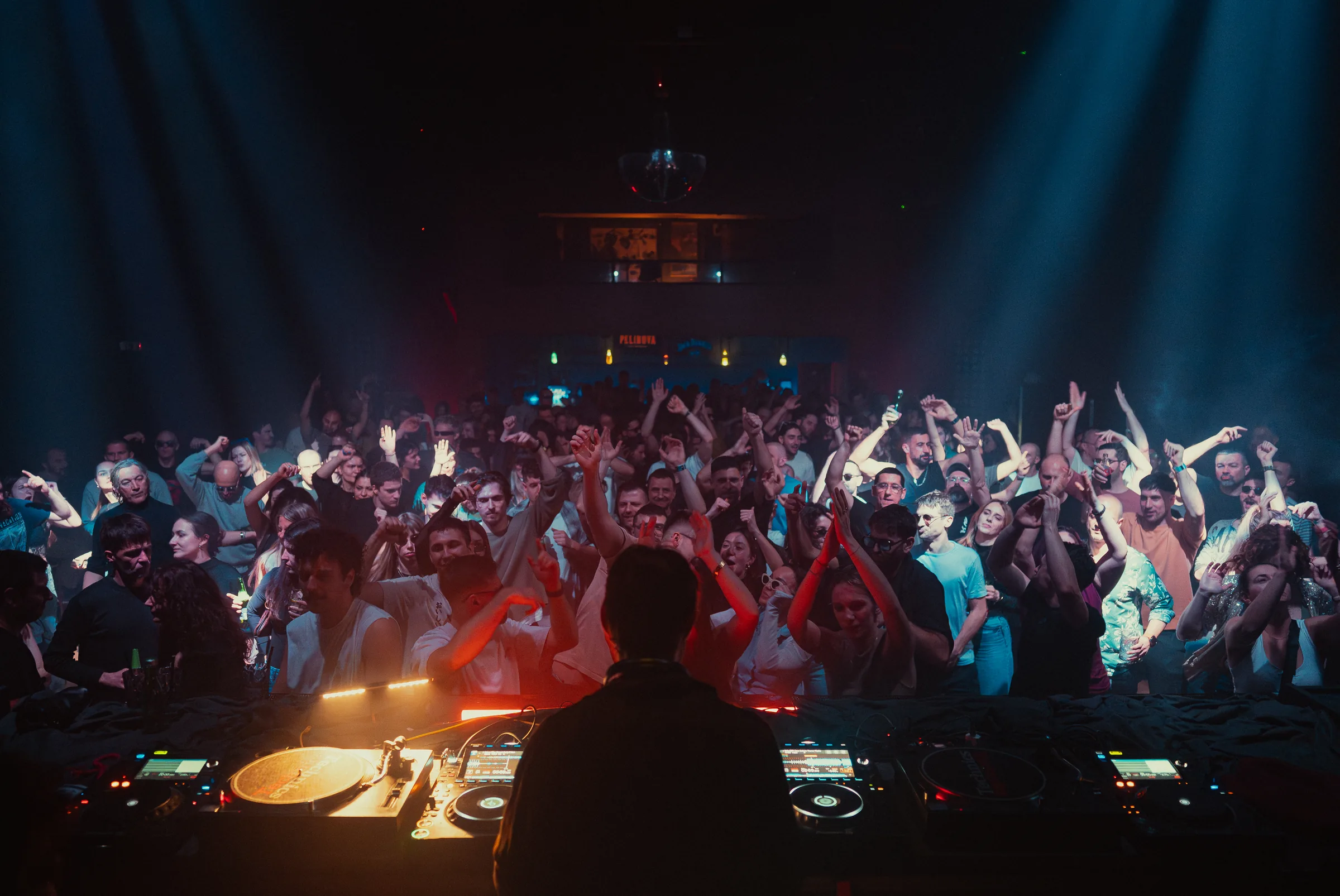 Peti Kupe audience photographed from the DJ booth during a club night.